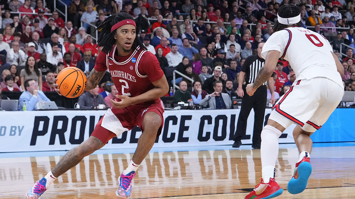 Arkansas Razorbacks guard Boogie Fland (2) dribbles against St. John's Red Storm guard Aaron Scott (0) during the second half of a second round men’s NCAA Tournament game at Amica Mutual Pavilion.