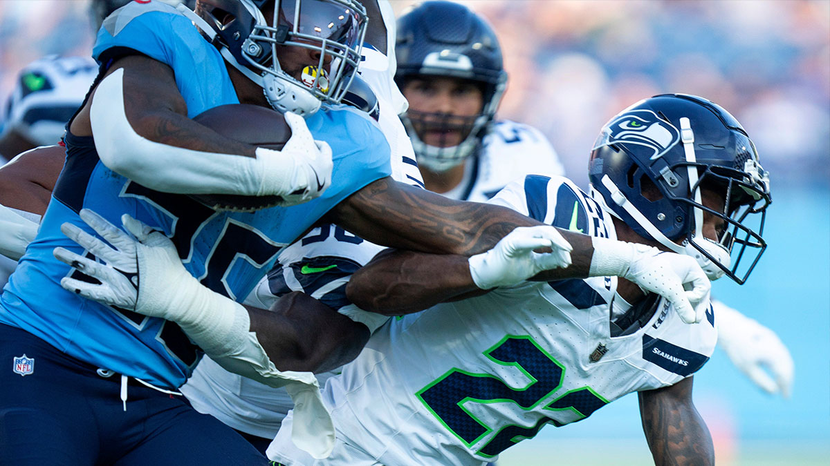 Tennessee Titans running back Julius Chestnut (36) fights through the tackle of Seattle Seahawks cornerback Artie Burns (23) during their game at Nissan Stadium in Nashvillet, Tenn., Saturday, Aug. 17, 2024.