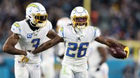 Jan 14, 2023; Jacksonville, Florida, USA; Los Angeles Chargers cornerback Asante Samuel Jr. (26) celebrates with safety Derwin James Jr. (3) after an interception during the second quarter of a wild card game against the Jacksonville Jaguars at TIAA Bank Field.