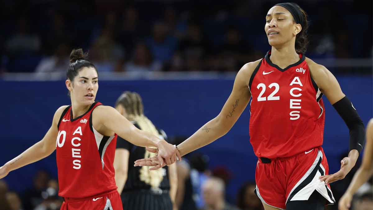Aug 25, 2024; Chicago, Illinois, USA; Las Vegas Aces center A'ja Wilson (22) is congratulated by guard Kelsey Plum (10) after scoring against the Chicago Sky during the first half at Wintrust Arena. Mandatory Credit: Kamil Krzaczynski-Imagn Images