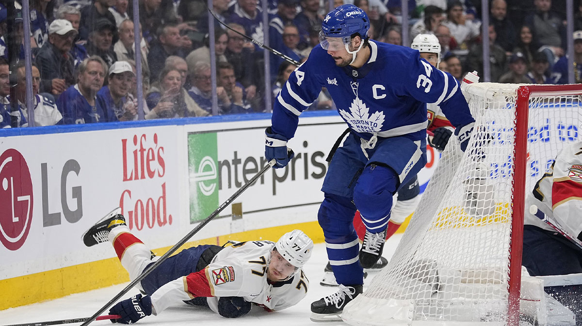 Toronto Maple Leafs forward Auston Matthews (34) gains control of the puck against Florida Panthers defenseman Niko Mikkola (77) during the first period of game five of the second round of the 2025 Stanley Cup Playoffs at Scotiabank Arena.