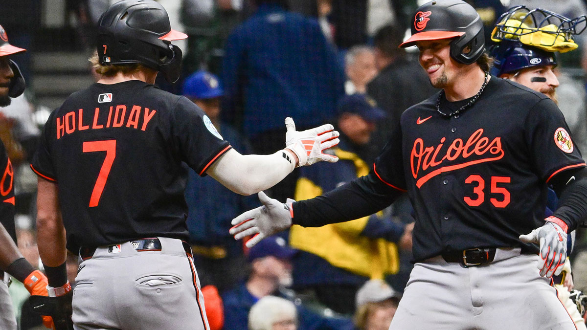 Baltimore Orioles catcher Adley Rutschman (35) is greeted by second baseman Jackson Holliday (7) after hitting a 3-run home run in the eleventh inning against the Milwaukee Brewers at American Family Field.