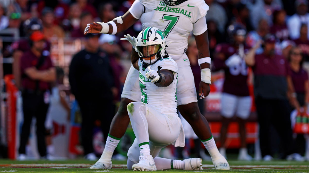 Marshall Thundering Herd defensive lineman Mike Green (15) celebrates after sacking Virginia Tech Hokies quarterback Kyron Drones (1) during the first quarter at Lane Stadium.