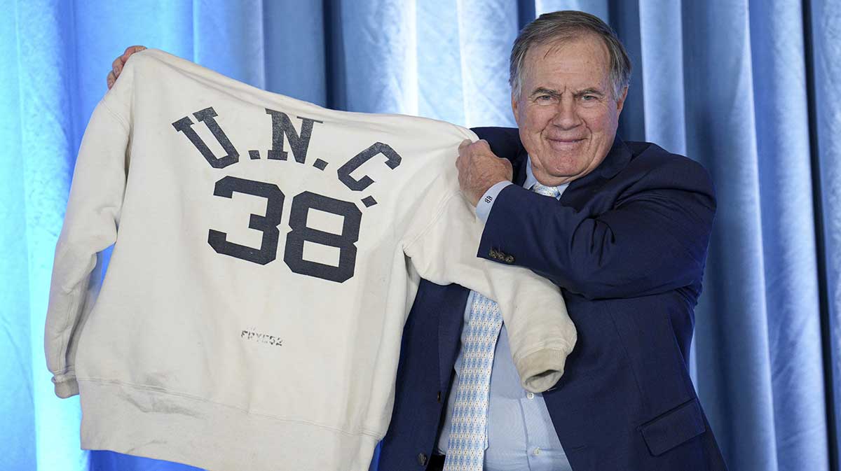 North Carolina Tar Heels new head coach Bill Belichick holds up the sweatshirt worn by his father when he was an assistant coach at New North Carolina Tar Heels new at Loudermilk Center for Excellence.