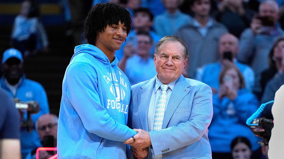 North Carolina Tar Heels head football coach Bill Belichick with recruit quarterback Bryce Baker during half time at Dean E. Smith Center.