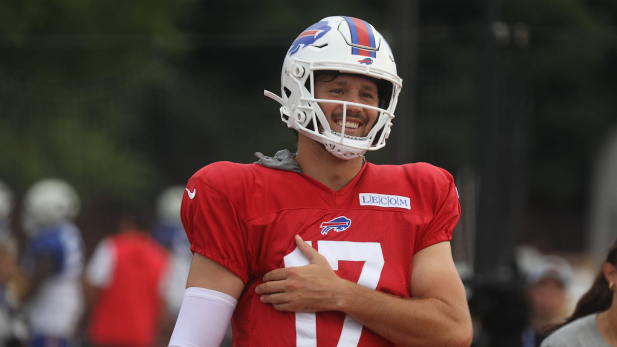 Bills Josh Allen laughs as he jokes with teammates as he moves to another practice field with other offensive players during Bills training camp