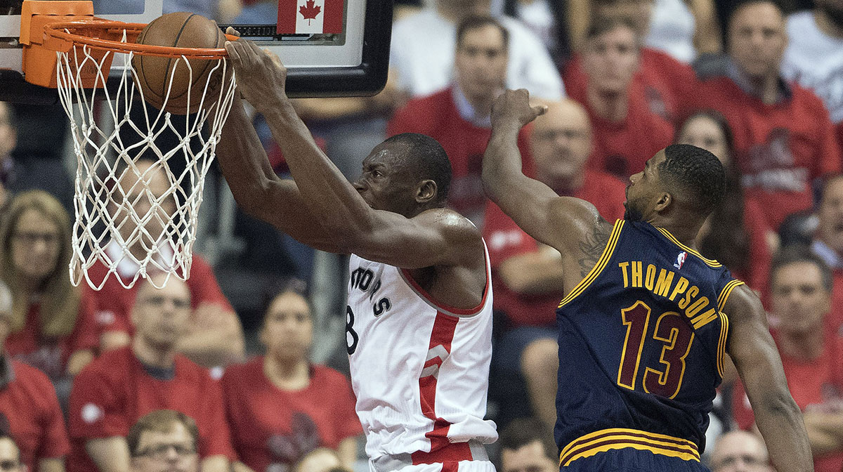 Toronto Raptors center Bismack Biyombo (8) scores a basket as Cleveland Cavaliers center Tristan Thompson (13) tries to defend during the first quarter of game six of the Eastern conference finals of the NBA Playoffs at Air Canada Centre.