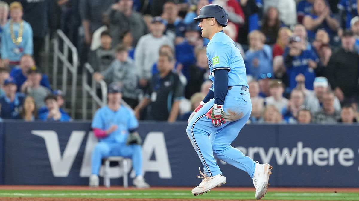 Toronto Blue Jays centre fielder Daulton Varsho (5) grabs his left leg after rounding second base against the Athletics during the third inning at Rogers Centre.