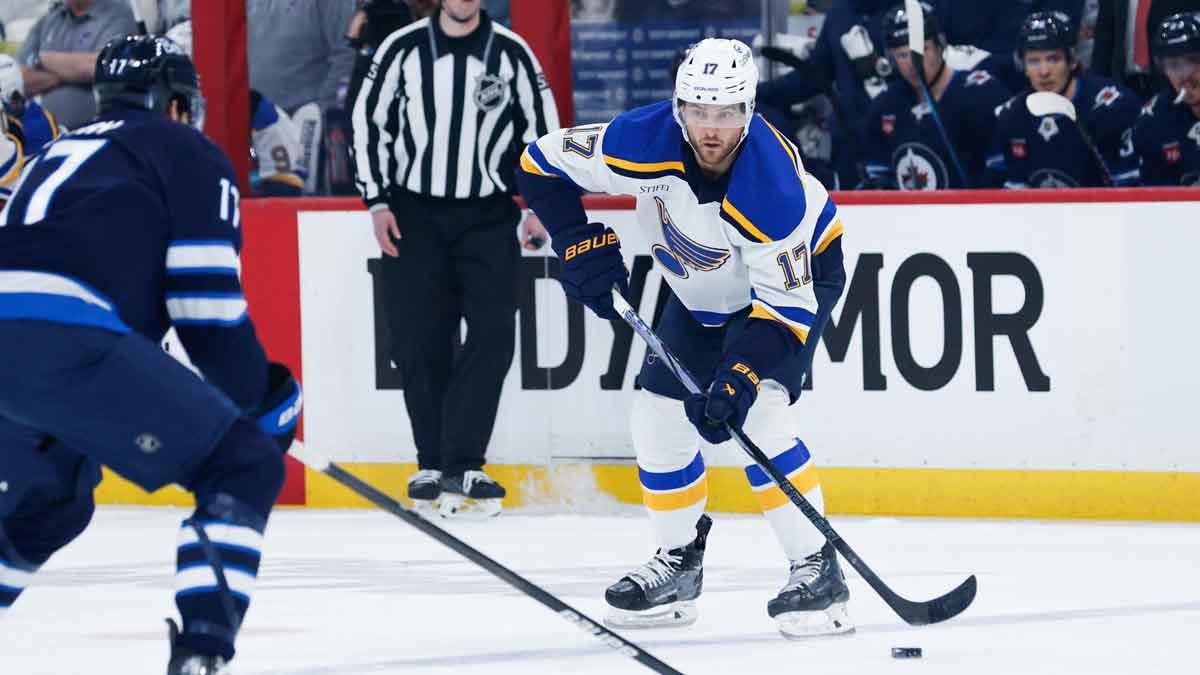 St. Louis Blues defenseman Cam Fowler (17) looks to make a play against Winnipeg Jets forward Adam Lowry (17) during the first period in game five of the first round of the 2025 Stanley Cup Playoffs at Canada Life Centre.
