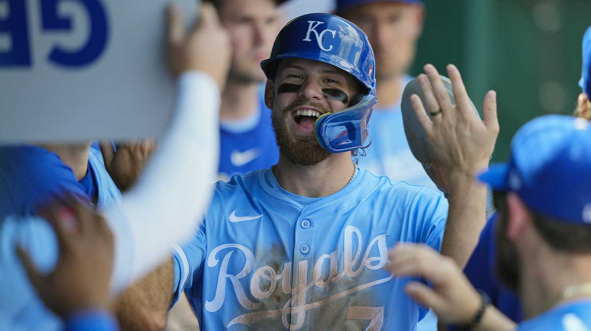 Kansas City Royals shortstop Bobby Witt Jr. (7) is congratulated by teammates after scoring a run during the fifth inning against the Chicago White Sox at Kauffman Stadium.