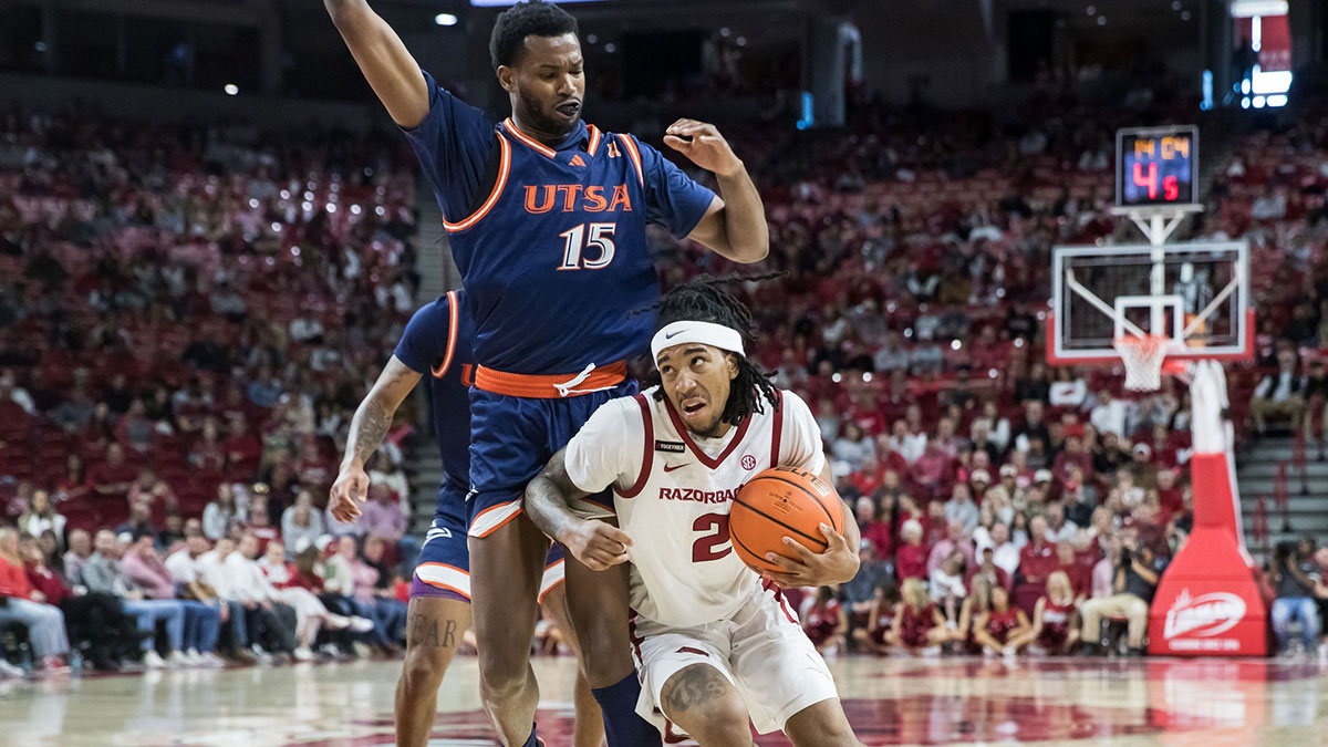Arkansas Razorbacks guard Boogie Fland (2) drives around Texas-San Antonio Roadrunners forward Jonnivius Smith (15) during the second half Bud Walton Arena. Arkansas won 75-60.