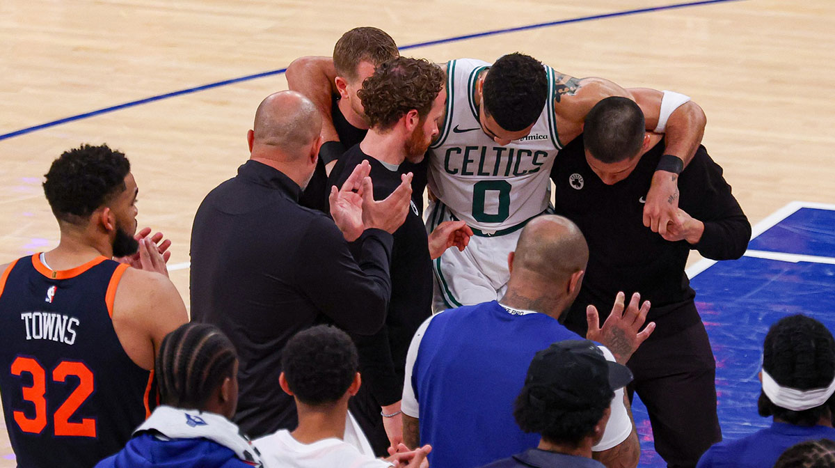Boston Celtics forward Jayson Tatum (0) is helped off the court by after an injury in the second half during game four of the second round for the 2025 NBA Playoffs against the New York Knicks at Madison Square Garden. Tatum would leave the game with an injury after this play.