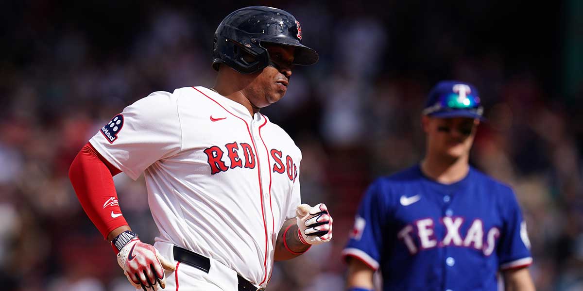 Boston Red Sox designated hitter Rafael Devers (11) hits a home run against the Texas Rangers in the seventh inning at Fenway Park.