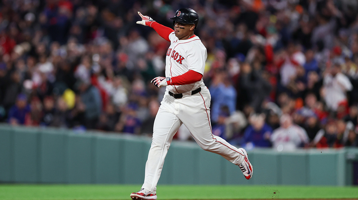Boston Red Sox designated hitter Rafael Devers (11) hits a solo home run during the fifth inning against the New York Mets at Fenway Park.