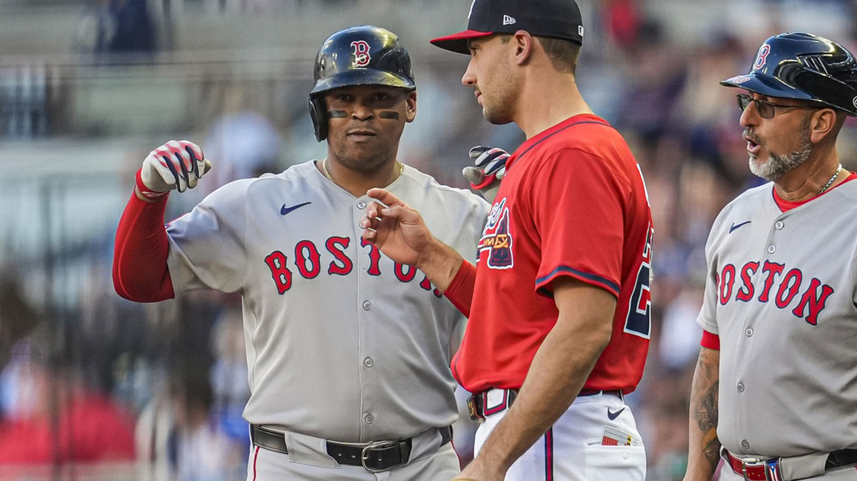Boston Red Sox designated hitter Rafael Devers (11) reacts after a getting a base hit against the Atlanta Braves during the first inning at Truist Park.