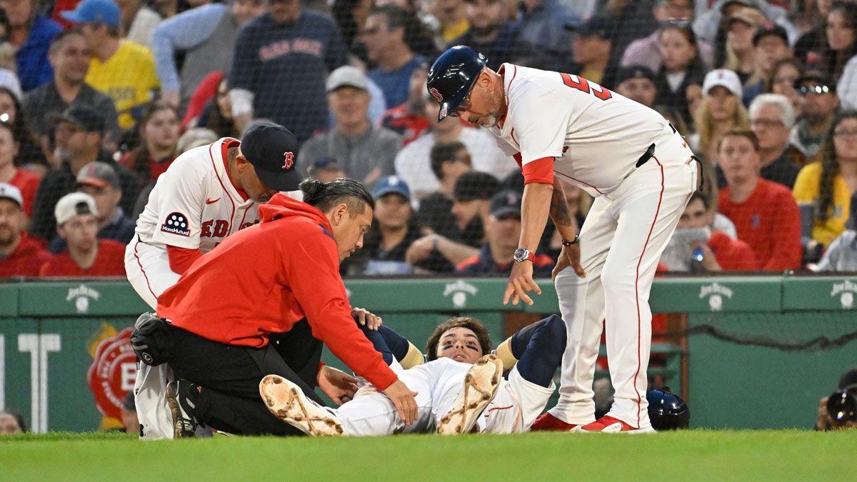 May 2, 2025; Boston, Massachusetts, USA; Boston Red Sox first baseman Triston Casas (36) is attended to by coaching and medical staff during the second inning against the Minnesota Twins at Fenway Park. Mandatory Credit: Eric Canha-Imagn Images