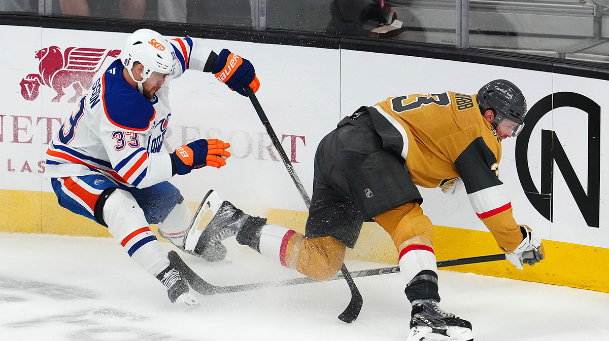 Edmonton Oilers left wing Viktor Arvidsson (33) trips Vegas Golden Knights defenseman Brayden McNabb (3) during an overtime period of game two of the second round of the 2025 Stanley Cup Playoffs at T-Mobile Arena.