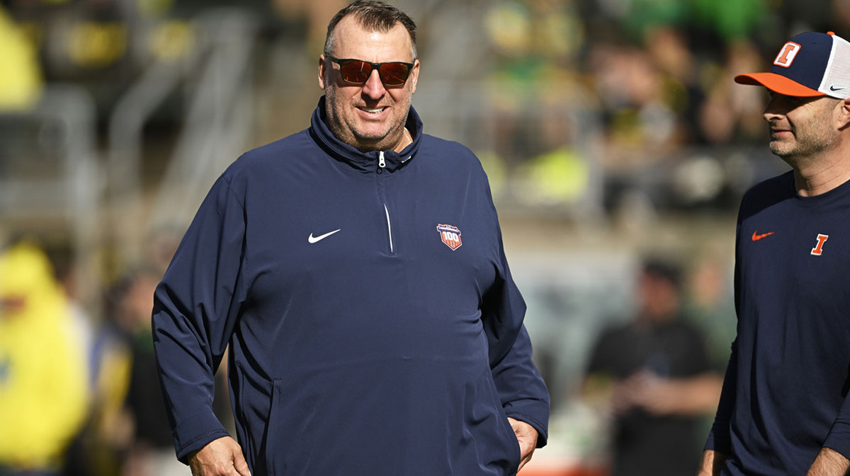 Illinois Fighting Illini head coach Bret Bielema watches players warm up before a game against the Oregon Ducks at Autzen Stadium.