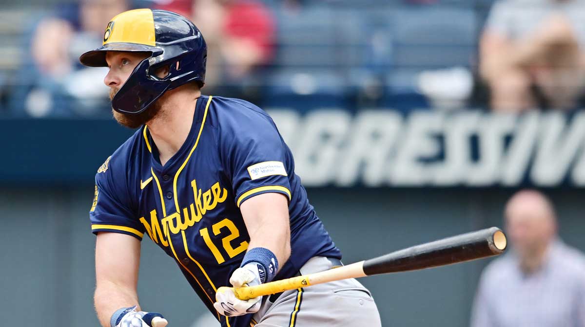 Milwaukee Brewers first baseman Rhys Hoskins (12) hits an RBI single during the ninth inning against the Cleveland Guardians at Progressive Field.