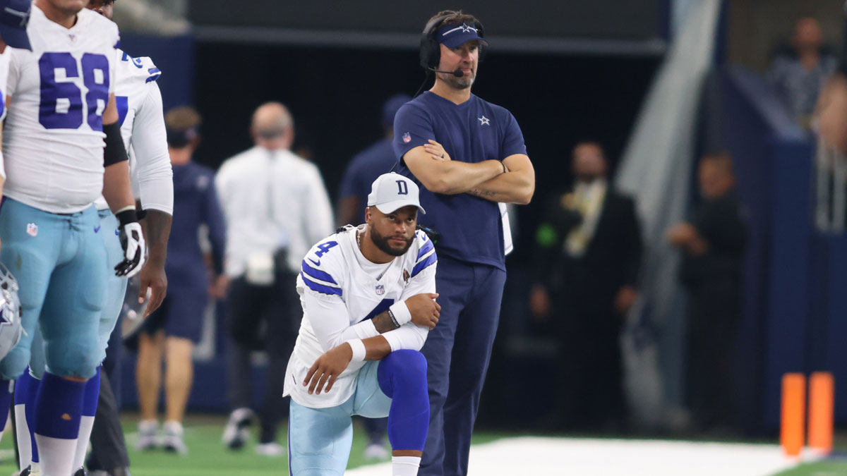 Dallas Cowboys quarterback Dak Prescott (4) and offensive coordinator Brian Schottenheimer watch a play in the game against the Jacksonville Jaguars at AT&T Stadium.
