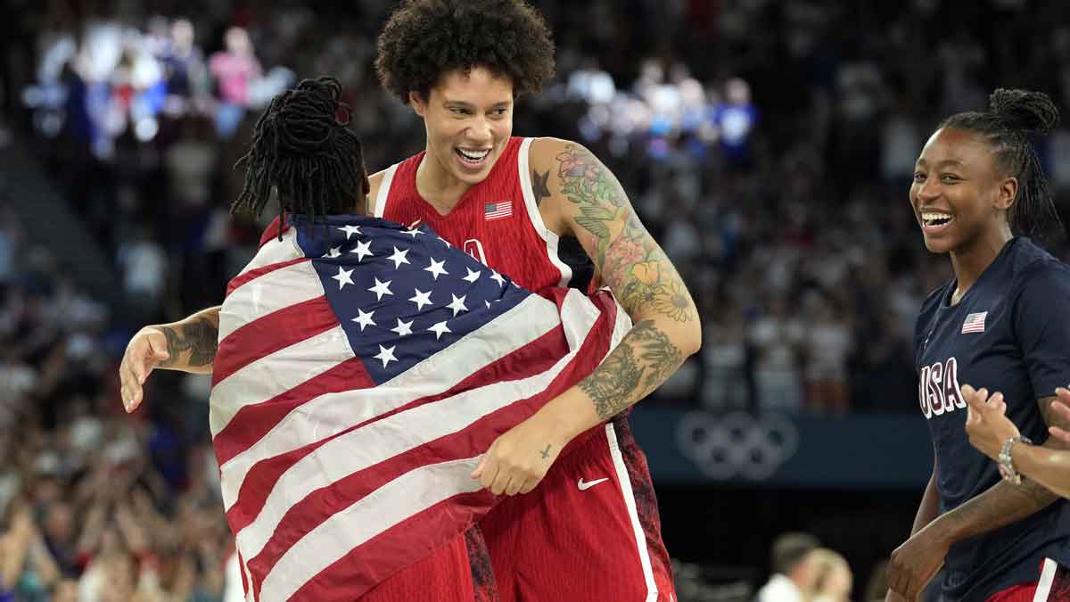 United States centre Brittney Griner (15) and guard Chelsea Gray (8) celebrate after defeating France in the women's gold medal game during the Paris 2024 Olympic Summer Games at Accor Arena.