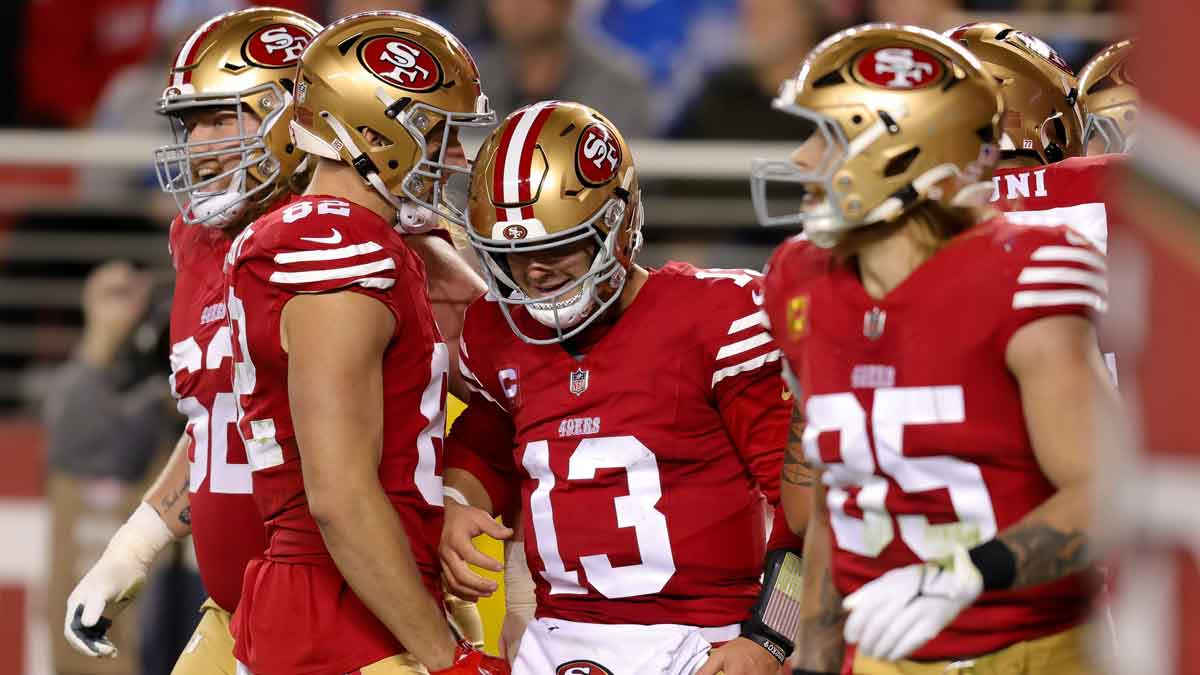 San Francisco 49ers quarterback Brock Purdy (13) is congratulated by teammates after scoring a touchdown during the second quarter against the Detroit Lions at Levi's Stadium.