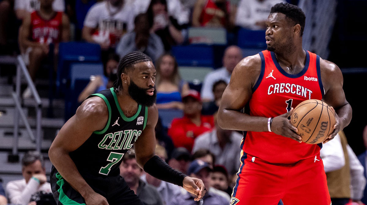 New Orleans Pelicans forward Zion Williamson (1) looks to pass the ball against Boston Celtics guard Jaylen Brown (7) during the first half at Smoothie King Center.