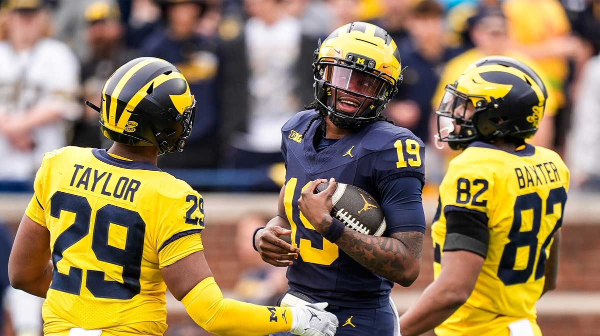 Team Blue Michigan quarterback Bryce Underwood (19) tries to run after recovering his fumble during the second half of the spring game at Michigan Stadium