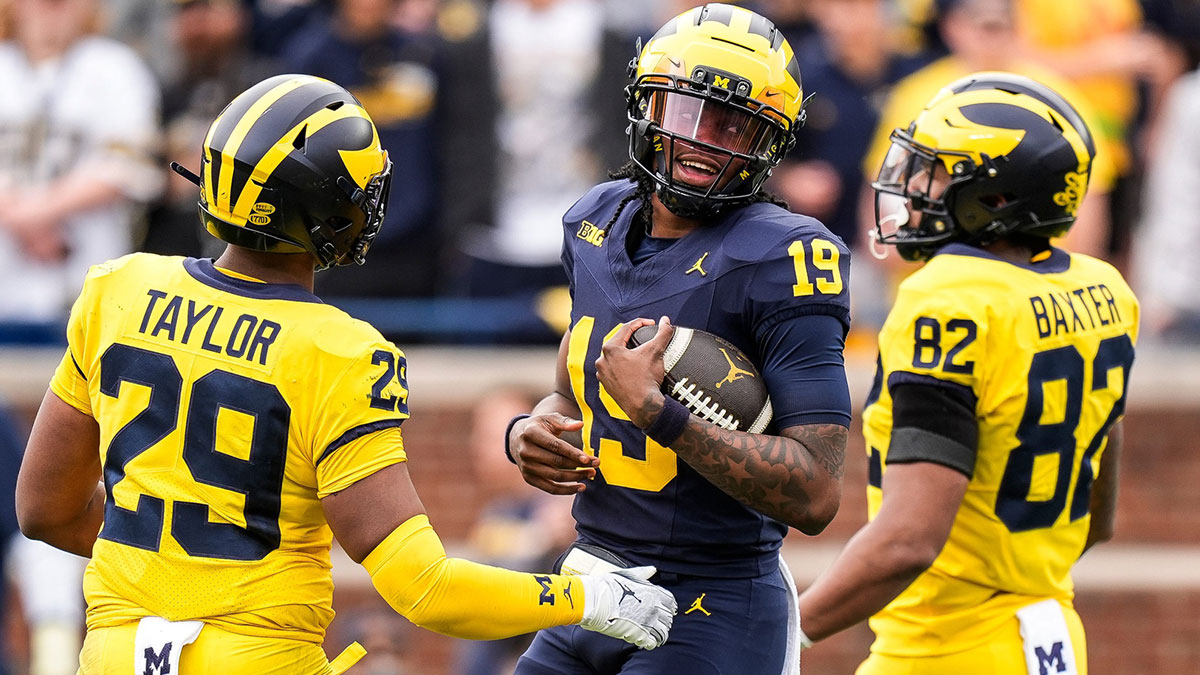 Team Blue Michigan quarterback Bryce Underwood (19) tries to run after recovering his fumble during the second half of the spring game at Michigan Stadium