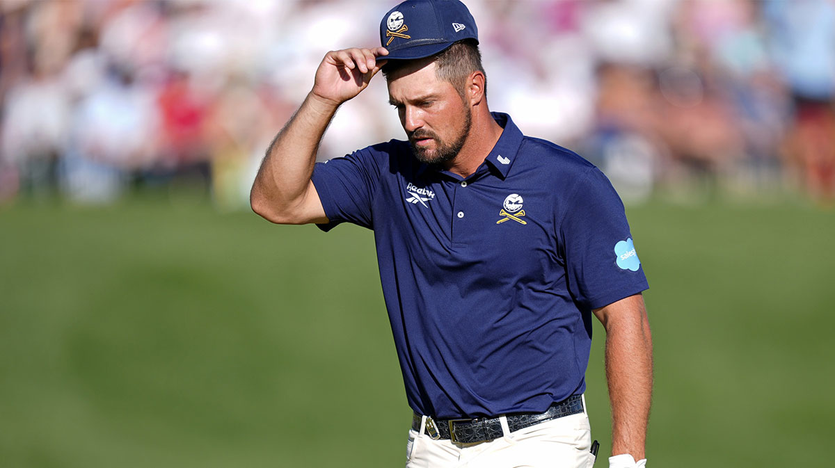 Bryson DeChambeau acknowledges fans while walking on the 18th green during the final round of the PGA Championship golf tournament at Quail Hollow.