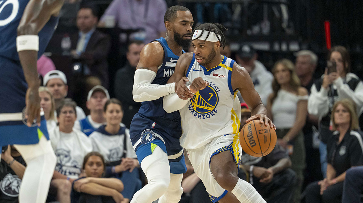 Golden State Warriors guard Buddy Hield (7) dribbles the ball as Minnesota Timberwolves guard Mike Conley (10) plays defense in the first half during game five of the second round for the 2025 NBA Playoffs at Target Center.