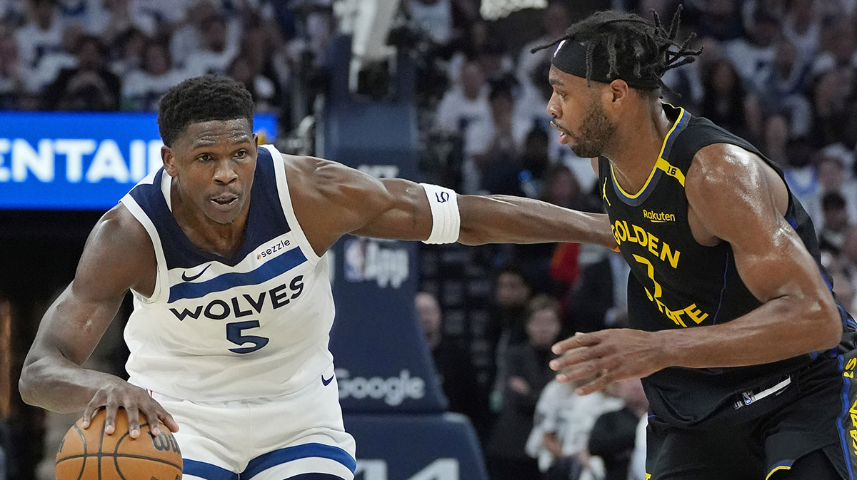 Minnesota Timberwolves guard Anthony Edwards (5) dribbles around Golden State Warriors forward Buddy Hield (7) in the first quarter during game one of the second round for the 2025 NBA Playoffs at Target Center.