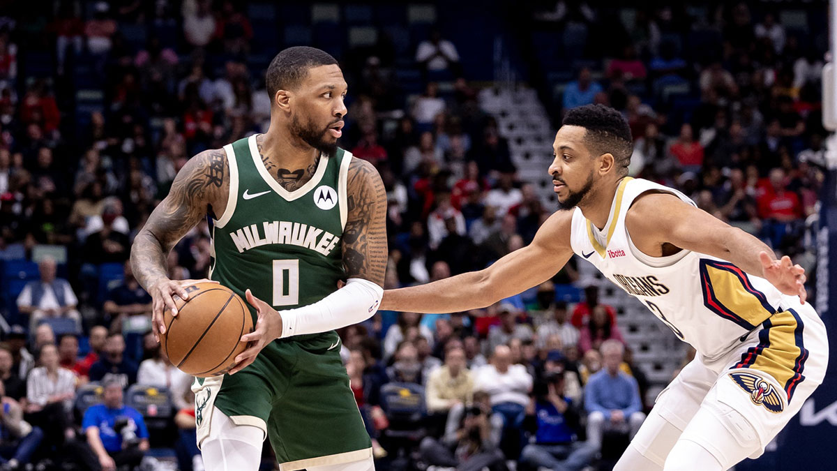 Milwaukee Bucks guard Damian Lillard (0) looks to pass the ball against New Orleans Pelicans guard CJ McCollum (3) during the first half at Smoothie King Center.