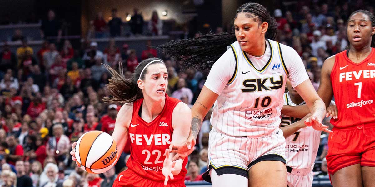 Indiana Fever guard Caitlin Clark (22) dribbles the ball while Chicago Sky center Kamilla Cardoso (10) defends in the first half at Gainbridge Fieldhouse.