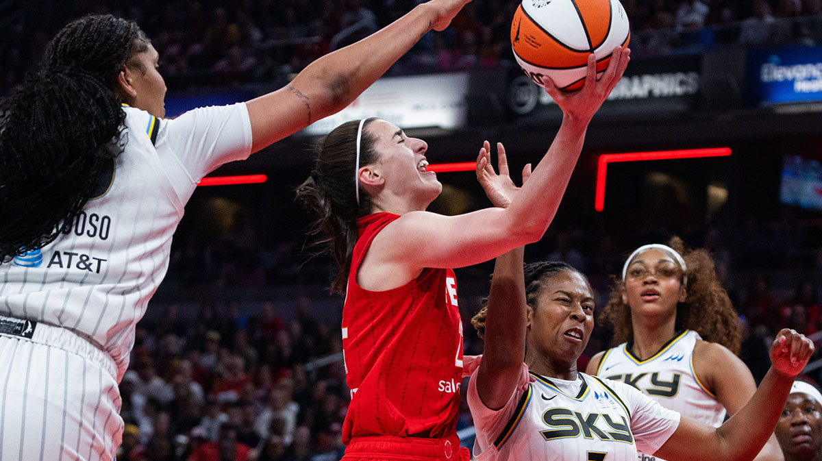 Indiana Fever guard Caitlin Clark (22) shoots the ball while Chicago Sky guard Ariel Atkins (7) defends in the first half at Gainbridge Fieldhouse.