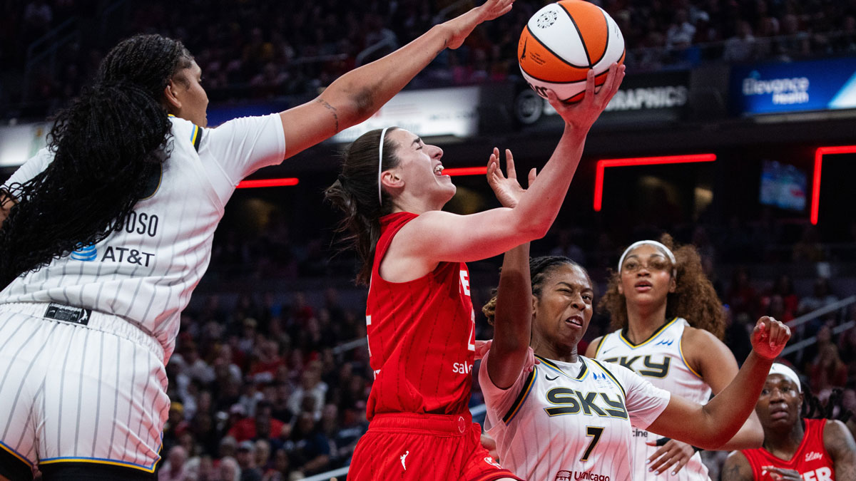 Indiana Fever guard Caitlin Clark (22) shoots the ball while Chicago Sky guard Ariel Atkins (7) defends in the first half at Gainbridge Fieldhouse.