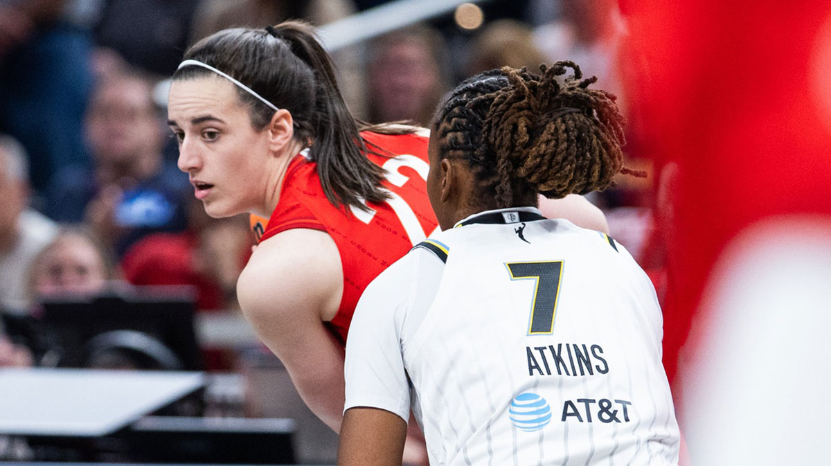 Indiana Fever guard Caitlin Clark (22) holds the ball while Chicago Sky guard Ariel Atkins (7) defends in the first half at Gainbridge Fieldhouse.