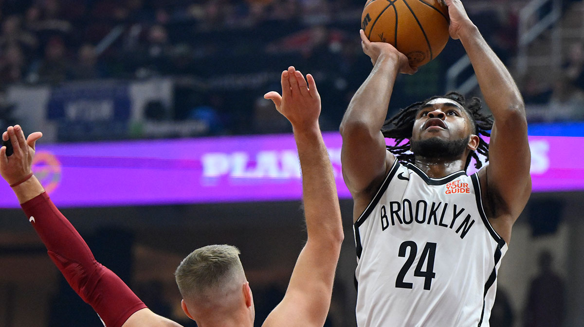 Brooklyn Nets guard Cam Thomas (24) shoots beside Cleveland Cavaliers guard Sam Merrill (5) in the first quarter at Rocket Arena.