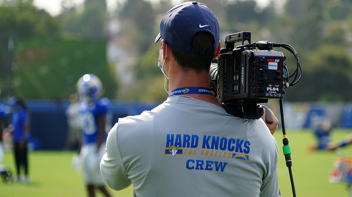 A HBO Hard Knocks film cameraman shoots video footage at Los Angeles Rams training camp at Cal Lutheran University.