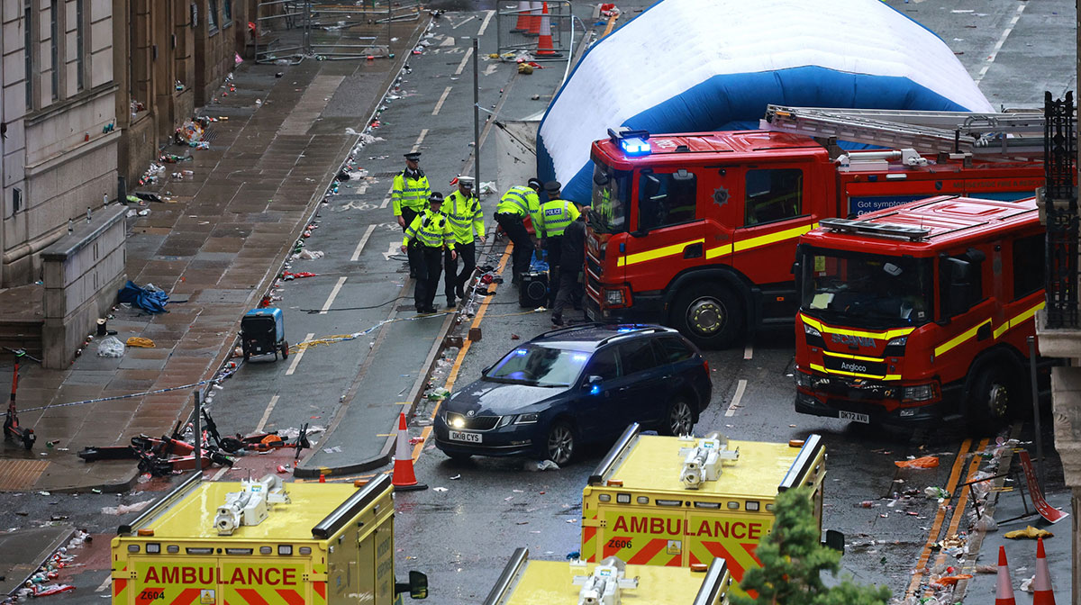 Emergency services at the scene after multiple people were hit by a car during the Liverpool football club victory parade.