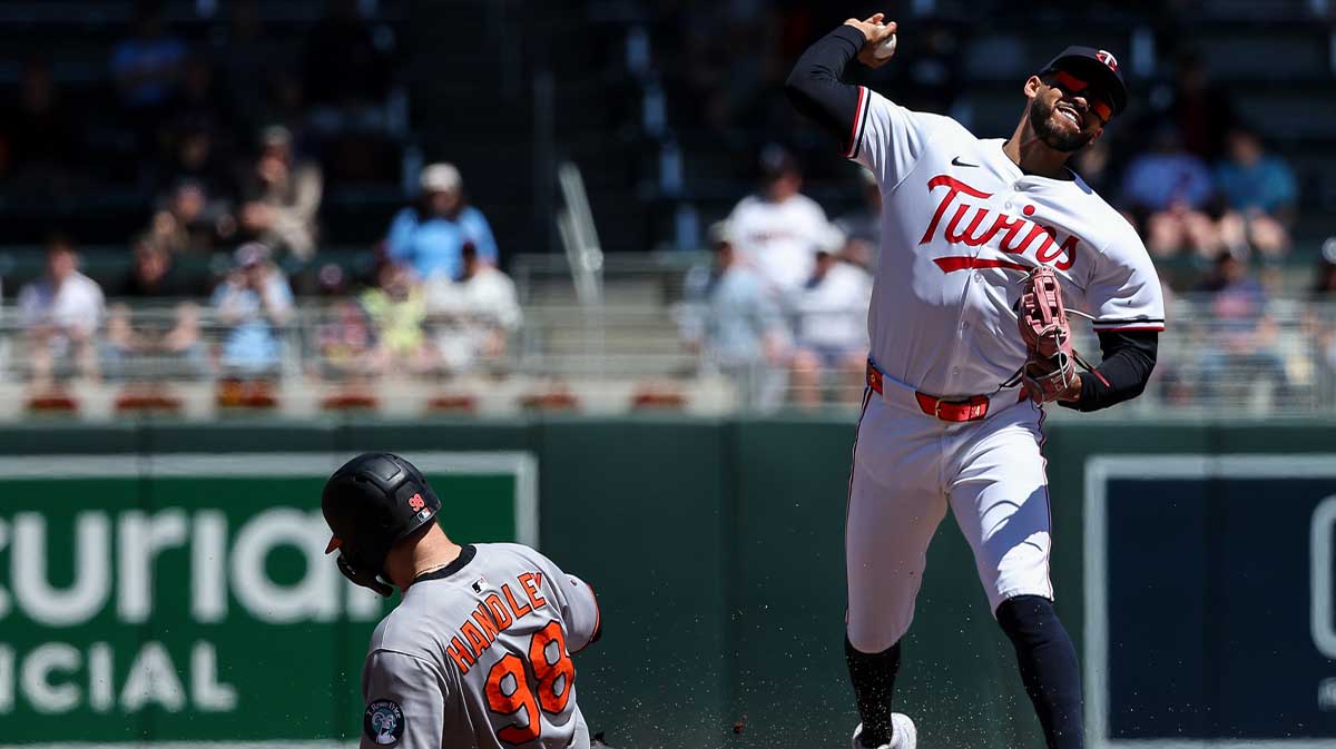 Minnesota Twins shortstop Carlos Correa (4) turns a double play against the Baltimore Orioles during the fourth inning at Target Field.
