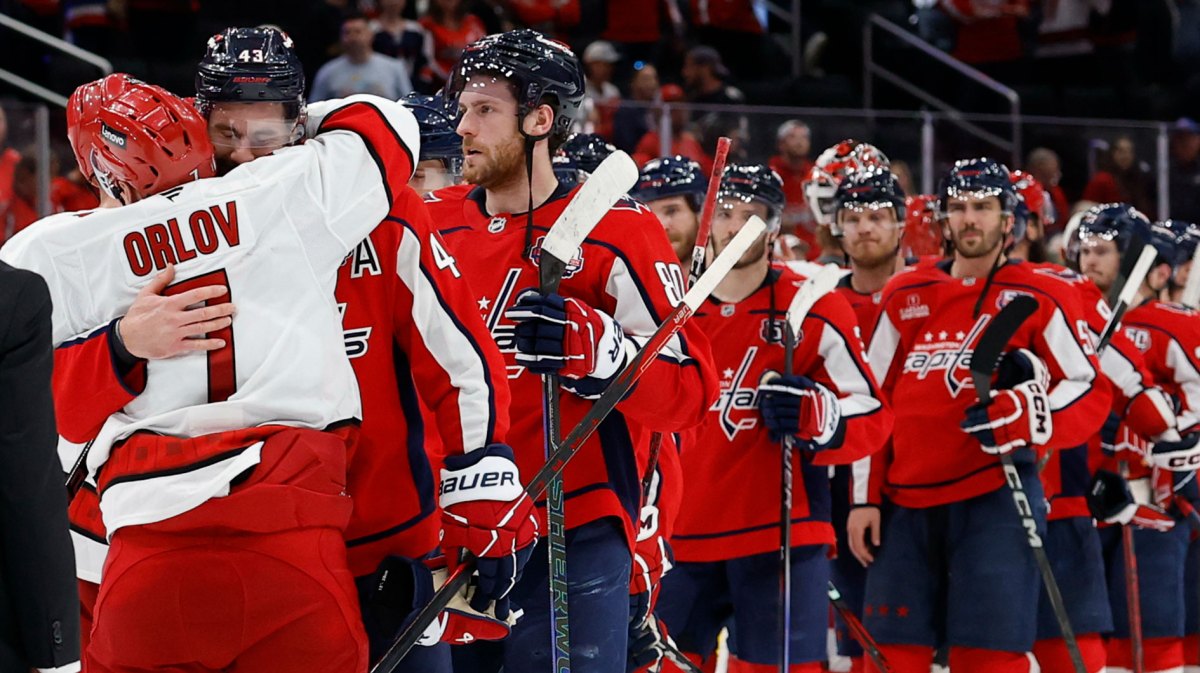 Carolina Hurricanes defenseman Dmitry Orlov (7) hugs Washington Capitals right wing Tom Wilson (43) in the handshake line after game five of the second round of the 2025 Stanley Cup Playoffs at Capital One Arena.