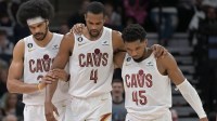 Cleveland Cavaliers forward Evan Mobley (4) is helped off the court by guard Donovan Mitchell (45) and center Jarrett Allen (31) during the second quarter at Target Center.