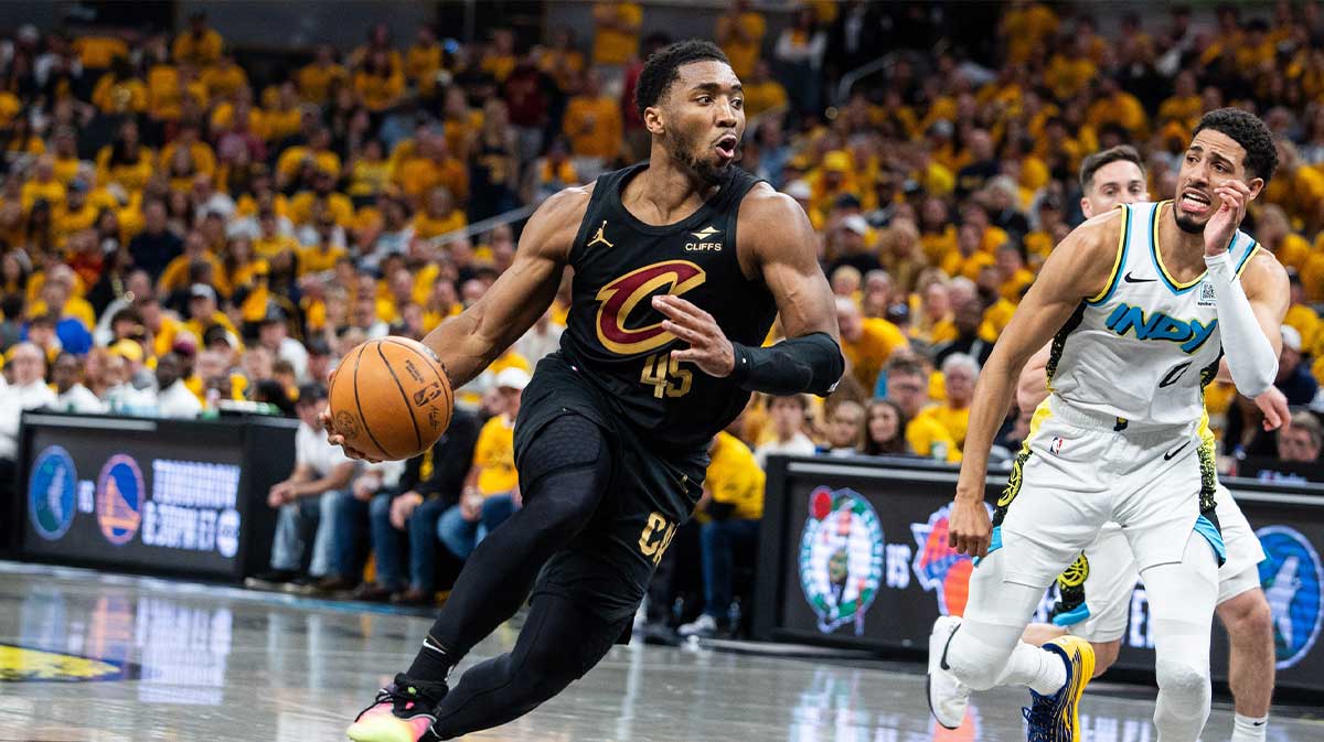 Cavs guard Donovan Mitchell (45) dribbles the ball while Indiana Pacers guard Tyrese Haliburton (0) defends