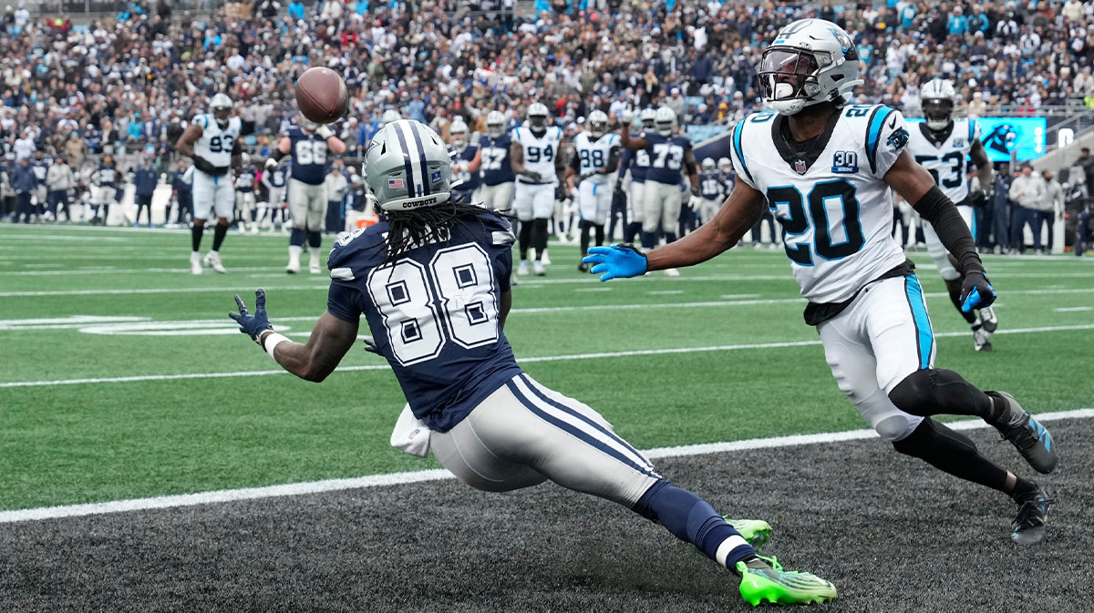 Dec 15, 2024; Charlotte, North Carolina, USA; Dallas Cowboys wide receiver CeeDee Lamb (88) scores a touchdown as Carolina Panthers safety Jordan Fuller (20) defends in the second quarter at Bank of America Stadium.