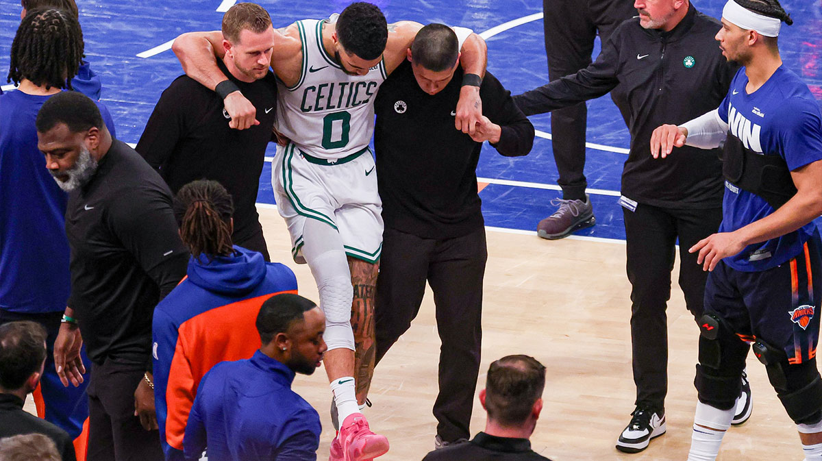 Boston Celtics forward Jayson Tatum (0) is helped off the court by after an injury in the second half during game four of the second round for the 2025 NBA Playoffs against the New York Knicks at Madison Square Garden. Tatum would leave the game with an injury after this play.