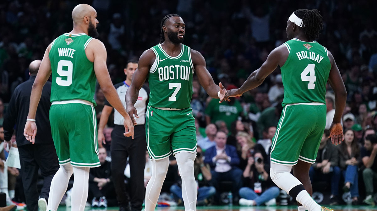 Boston Celtics guard Jaylen Brown (7), guard Jrue Holiday (4) and guard Derrick White (9) react after a play against the New York Knicks in the second half at TD Garden.