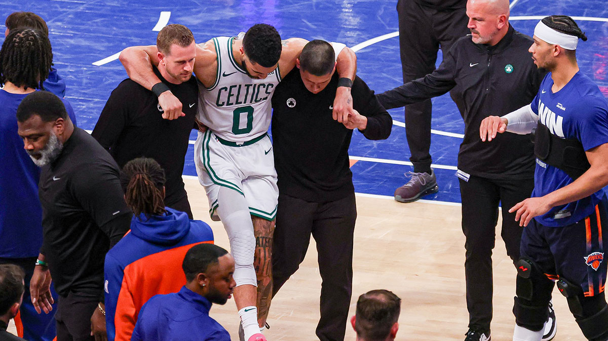 Boston Celtics forward Jayson Tatum (0) is helped off the court by after an injury in the second half during game four of the second round for the 2025 NBA Playoffs against the New York Knicks at Madison Square Garden. Tatum would leave the game with an injury after this play.