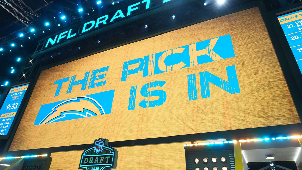 The Los Angeles Chargers logo is projected on the video board during the NFL Draft at Lambeau Field.