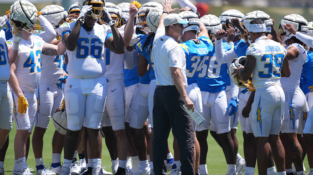 Los Angeles Chargers coach Jim Harbaugh huddles with players during rookie minicamp at The Bolt.